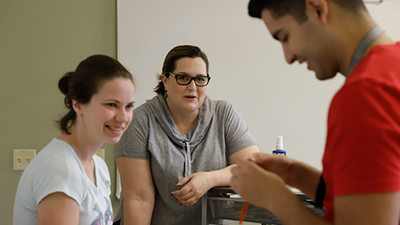 Department of Chemical and Biological Engineering Professor Heather Canavan, center, teaching students. Canavan was a winner in 2018 of the Women in STEM Awards, one key initiative of the ADVANCE program. Heather Canavan Teaching