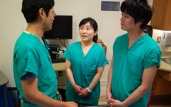 UNMH's Dr. Tatsuya Norii, left talks with Sendai City Hospital residents Kimiko Sato and Satoru Meguro.