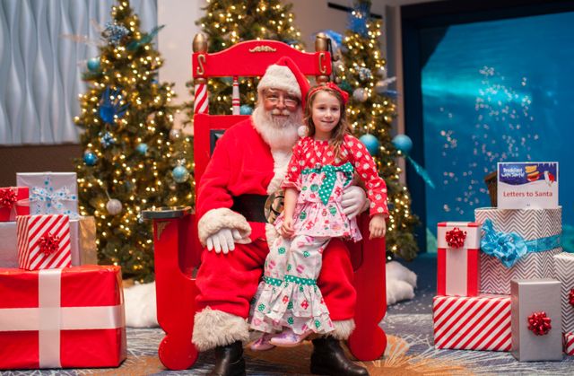 Little girl sits with Santa Claus. Breakfast-W-Santa-74