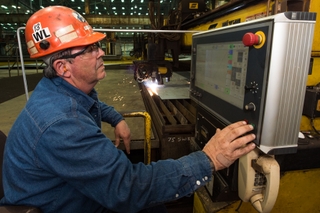 Paul Bosarge, a steel fabrication burner at Ingalls Shipbuilding, presses the button to start fabrication of the Ingalls-built destroyer Lenah H. Sutcliffe Higbee (DDG 123). Bosarge has worked at Ingalls for 39 years. Photo by Lance Davis/HII Ingalls Starts Fabrication on DDG 123