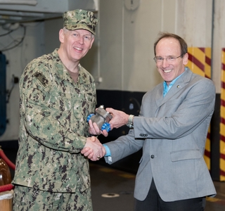 Don Hamadyk, Newport News Shipbuilding's director of research and development, presented the first 3D printed metal part to Rear Adm. Lorin Selby, Naval Sea Systems Command’s chief engineer and deputy commander for ship design, integration, and naval engineering during a brief ceremony on USS Harry S. Truman (CVN 75). Photo by Matt Hildreth/HII. 3D Printed Part Delivered to Navy