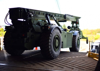 A Rough Terrain Container Handler is offloaded after Virginia-based Technical Solutions employees repaired a steering casualty. Photo courtesy of Department of Defense Rough Terrain Container Handler