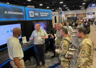 Vice Adm. Collin Green, deputy commander, U.S. Special Operations Command, views a demonstration of HII artificial intelligence platforms that distill and curate the most meaningful data for near real time missions. HII AI at SOFIC 2022