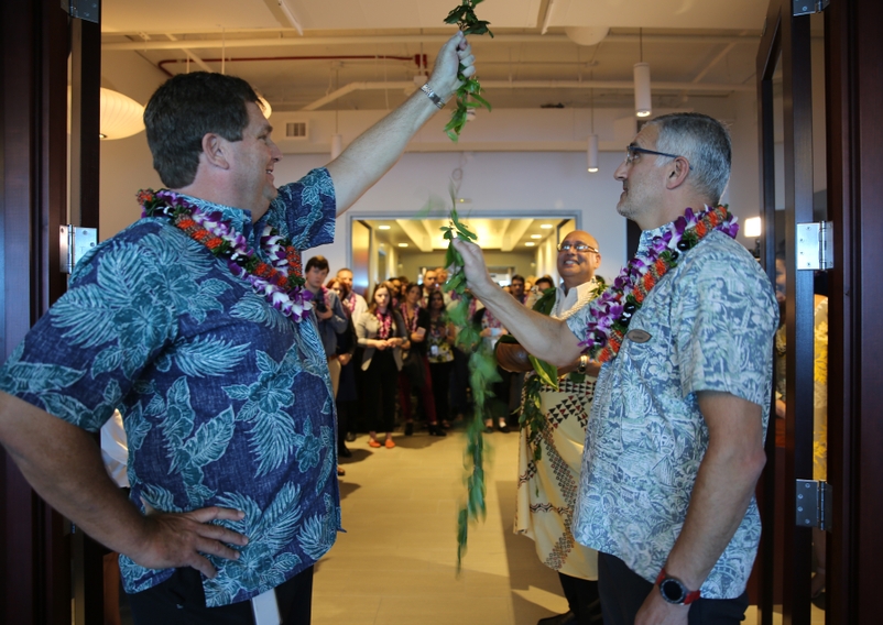 From left: John Jacobi, senior vice president for IT at Hawaiian Airlines, joined Matthew Chimbos, managing director of IT at Hawaiian, in untying a maile lei to dedicate the carrier's new IT center in Tempe, Ariz. Hawaiian IT Maile Lei