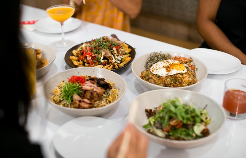 Meals are best enjoyed in the company of others, including this spread of local favorites at Redfish Poke Bar by Foodland. hawaiianairlines-web-preview-244