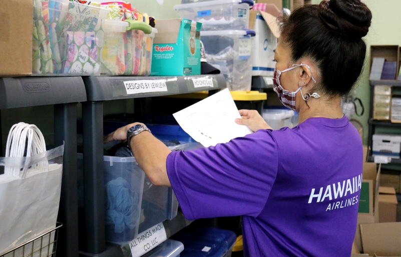 A Team Kōkua volunteer helping pull and prepare orders at the Pop-Up Mākeke headquarters. TK1
