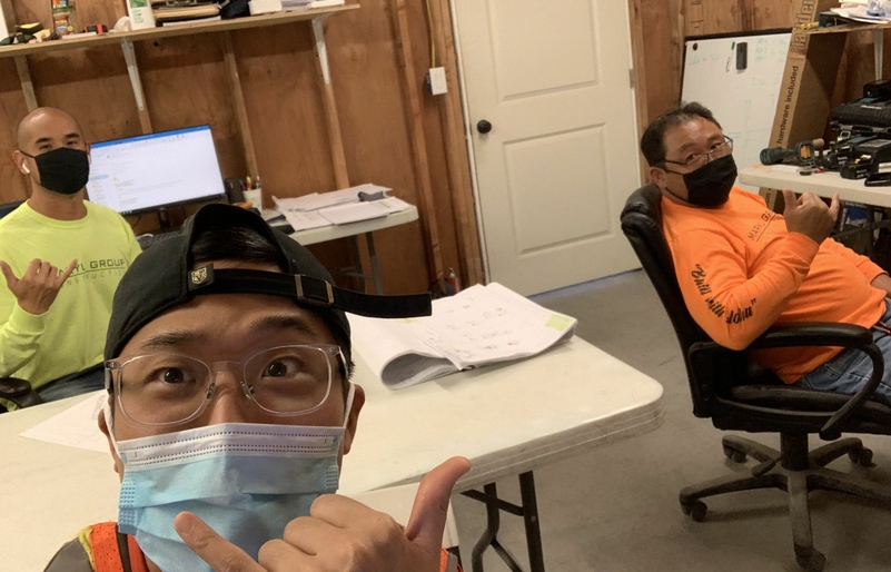 Choi, pictured front, takes a selfie with his colleagues while behind the scenes of a retail project in Kona. IMG_3707