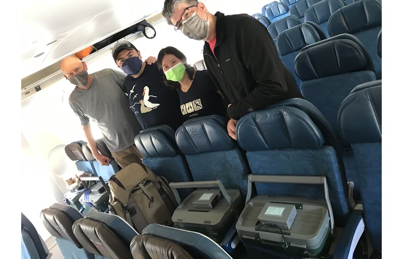 VanderWerf (far left) and his team onboard Hawaiian's Airbus A330 with incubators filled with Kaʻupu eggs IMG_4147