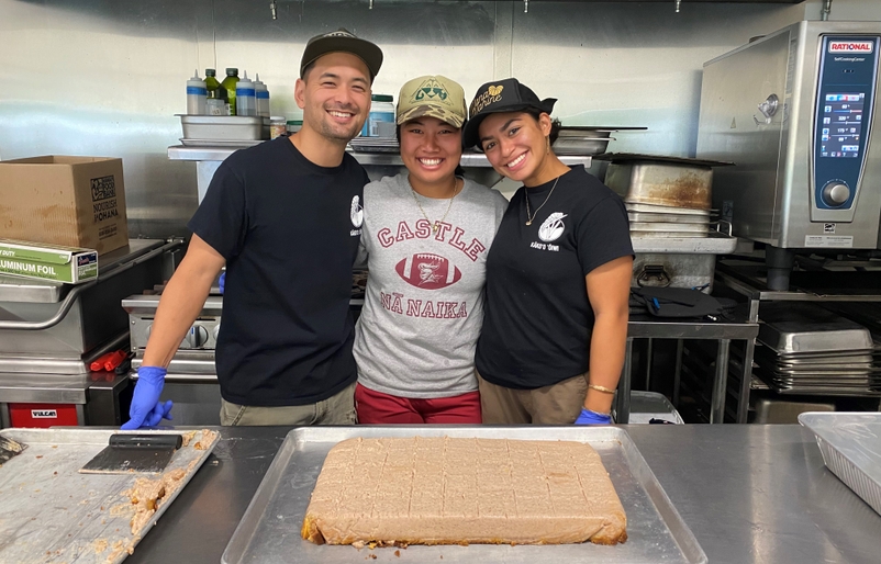 Dochin, Kiakona and Damaso (L to R) gather around a sheet of delicious taro crunch cake made with ingredients from the farm for our Team Kōkua volunteers. 3