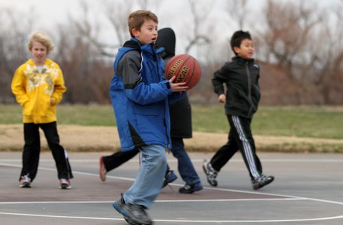 Boys playing basketball outsidecopyright American Heart Association