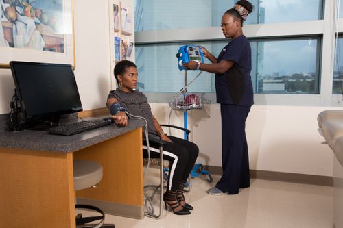 Nurse taking blood pressure of female patient at UTSW Medical Center in Dallas, Texascopyright American Heart Association