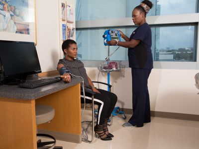 Nurse taking blood pressure of female patient at UTSW Medical Center in Dallas, Texascopyright American Heart Association