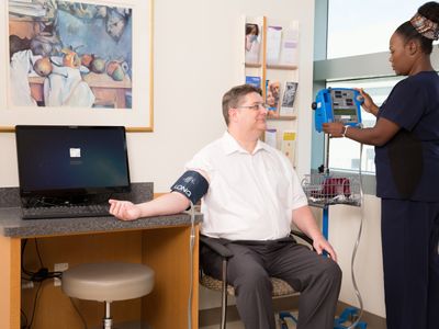 Nurse taking blood pressure of male patient at UTSW Medical Center in Dallas, Texascopyright American Heart Association