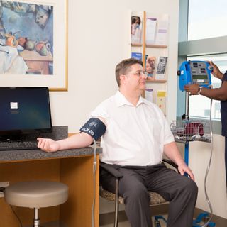 Nurse taking blood pressure of male patient at UTSW Medical Center in Dallas, Texascopyright American Heart Association