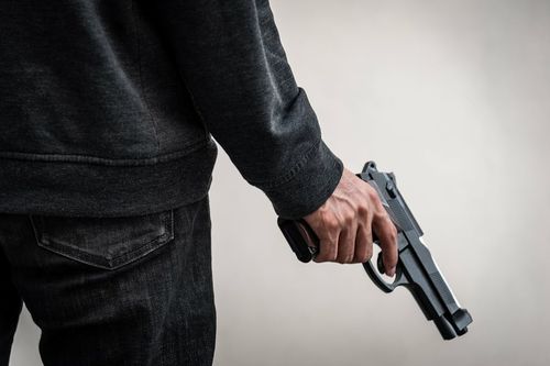 bigstock-A-Man-Holding-A-Gun-In-Hand-T-299137612-4