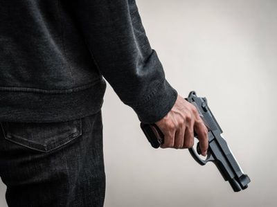 bigstock-A-Man-Holding-A-Gun-In-Hand-T-299137612-4