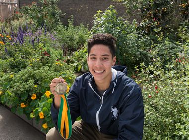 Edison Scholar Justin Hogenauer in front of a sustainable garden he helped build at his school. Edison Scholar Justin Hogenauer