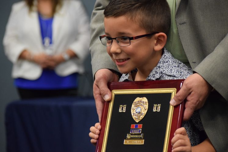 CCPD's Capt. J.V. Garcia's grandson receives his retirement plaque