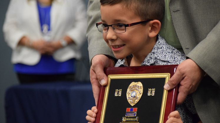 CCPD's Capt. J.V. Garcia's grandson receives his retirement plaque