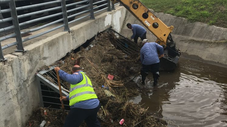 Storm Water Employees Clear Grate Screens of Debris Before Storm