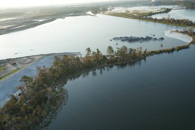Sutton 1971 coal ash basin inundated by cooling lake; ash continues to be retained behind steel wall. Photo uploaded on Sept. 21, 2018.