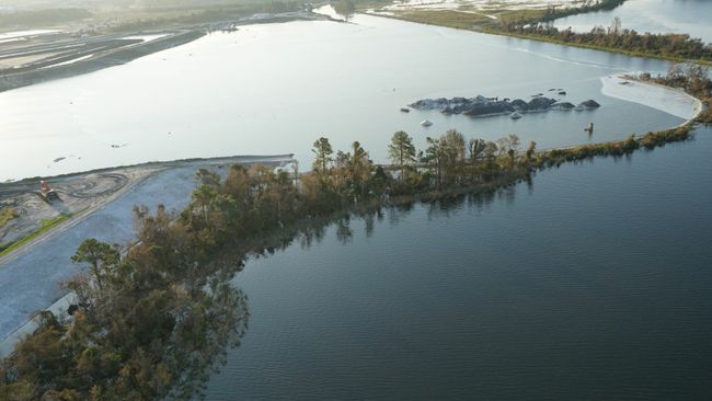 Sutton 1971 coal ash basin inundated by cooling lake; ash continues to be retained behind steel wall. Photo uploaded on Sept. 21, 2018.