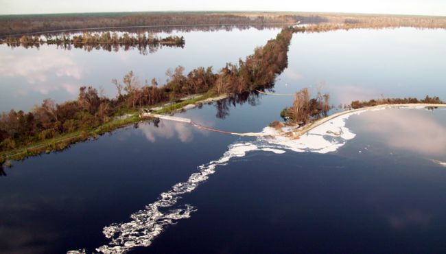 Booms at Sutton Plant discharge canal retain cenospheres in the 1971 ash basin. Photo uploaded on Sept. 22, 2018.
