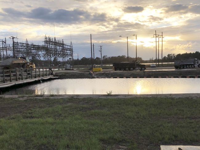 Moving material to construct an access road to reach the primary breaches on the Sutton Lake dam. Photo uploaded Sept. 24, 2018