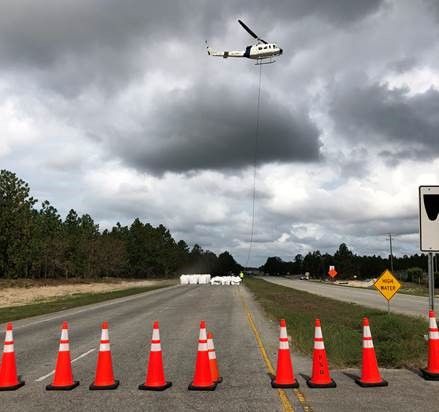 Helicopter operation to left large sandbags and place them inside the breach locations along Sutton Lake dam to help slow the flow of water going out. Photo uploaded Sept. 26, 2018.