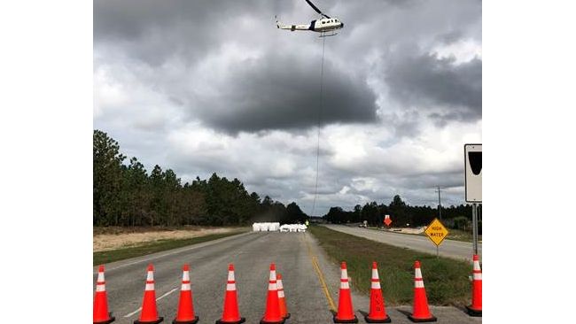 Helicopter operation to left large sandbags and place them inside the breach locations along Sutton Lake dam to help slow the flow of water going out. Photo uploaded Sept. 26, 2018.