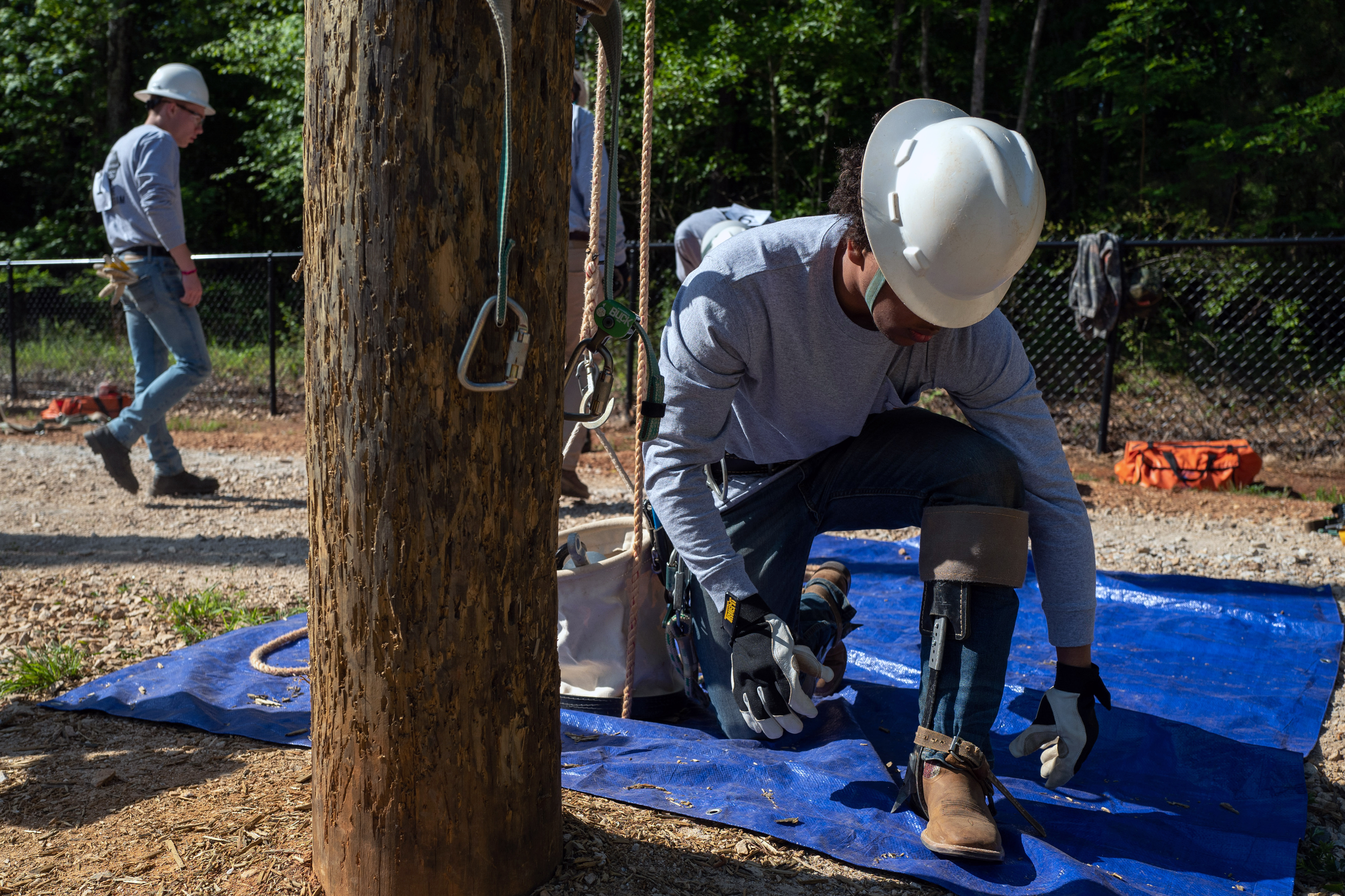 A student lineworker gets ready to climb a utility pole at the York Comprehensive High School rodeo. 2022-0510-alumni-6