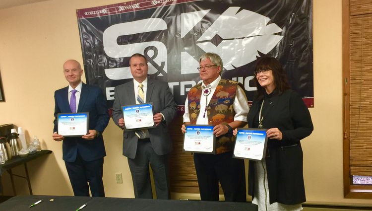 L to R: Steven Michaels, Northrop Grumman; David Sikora, United States Air Force; Larry Hall, S&K Electronics; and Sandra Boham, S&K College display the signed mentor protégé partnership certificates. Northrop Grumman Signs Mentor Protégé Agreement with S&K Electronics