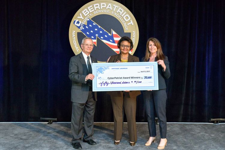 Linnie Haynesworth, vice president and general manager, cyber and intelligence mission solutions division, Northrop Grumman Mission Systems presented $50,500 in scholarships to students on the winning high school teams of the CyberPatriot IX National Finals Competition on April 5. On behalf of the company, Haynesworth presented the check to CyberPatriot Commissioner Bernie Skoch (left), and Denise Hollywood, Executive Vice President, Air Force Association (right). Photo by David Keith Photography. Northrop Grumman Awards $50,000 in Scholarship Funds to Winning Teams of CyberPatriot IX