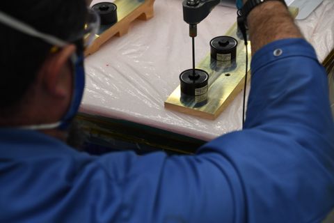 A Northrop Grumman technician prepares mounting hardware for the ThinSats stack before installing on the Antares rocket. (Image credit: Virginia Space)
