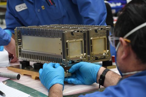 A Northrop Grumman technician secures a ThinSat Stack to mounting hardware for a launch on the Antares rocket. (Image credit: Virginia Space)