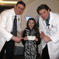 Genevieve Olson Rocha, with, from left, John Holland, M.D., associate professor, and Aaron Martin, radiation therapist