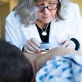 Sancy Leachman, M.D., Ph.D., performs a skin check.