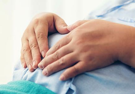 Pregnant woman lying on the bed waiting to give birth in a hospital.