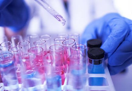 female lab technician doing research with a microscope in the lab. coronavirus