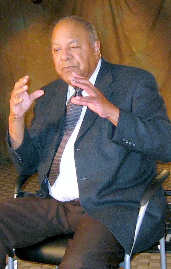 Dr. Walter C. Reynolds, sitting in a chair, during the taping of his oral history interview at the Oregon Medical Association offices