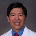 Headshot of David M. Lee M.D., a smiling Asian man in a white lab coat.