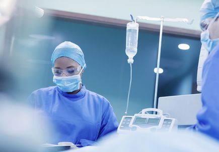 Doctors performing surgery in hospital operating room