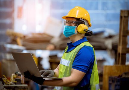 Portrait man worker under inspection and checking production process on factory station by wearing safety mask to protect for pollution and virus in factory.