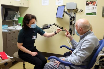 Marian Dale, M.D., M.C.R., with patient
