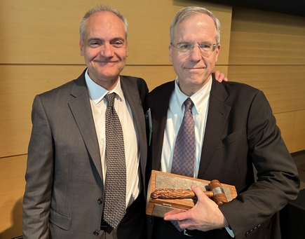 Nathan Selden, M.D., Ph.D., right, (short gray hair, glasses) with the gavel he accepted on May 19 as the incoming president of SNS, standing with now-past president Antonio Chiocca, M.D., Ph.D., (short gray hair)chair of neurosurgery, Brigham and Women’s Hospital/Harvard Medical School..