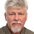 Carsten Schultz, Ph.D., has short silvery-white hair, facial hair and a brown shirt.
