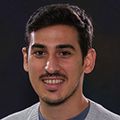 Carlos M. Soto-Faguas, Ph.D., has short dark hair, a white sweater, smiling against a black background.