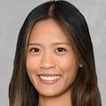 Christine Nguyen Dawson, M.D., tiene cabello castaño ondulado, una chaqueta de vestir negra y está sonriendo.