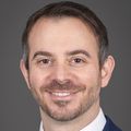 Oren Shaked, M.D., has short dark hair, a suit on and is smiling.