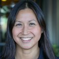 Jamie Lo, M.D., M.C.R. (OHSU) Jamie Lo, M.D., M.C.R. (OHSU) has long dark hair and is wearing a black sweater, standing in a garden area at OHSU.